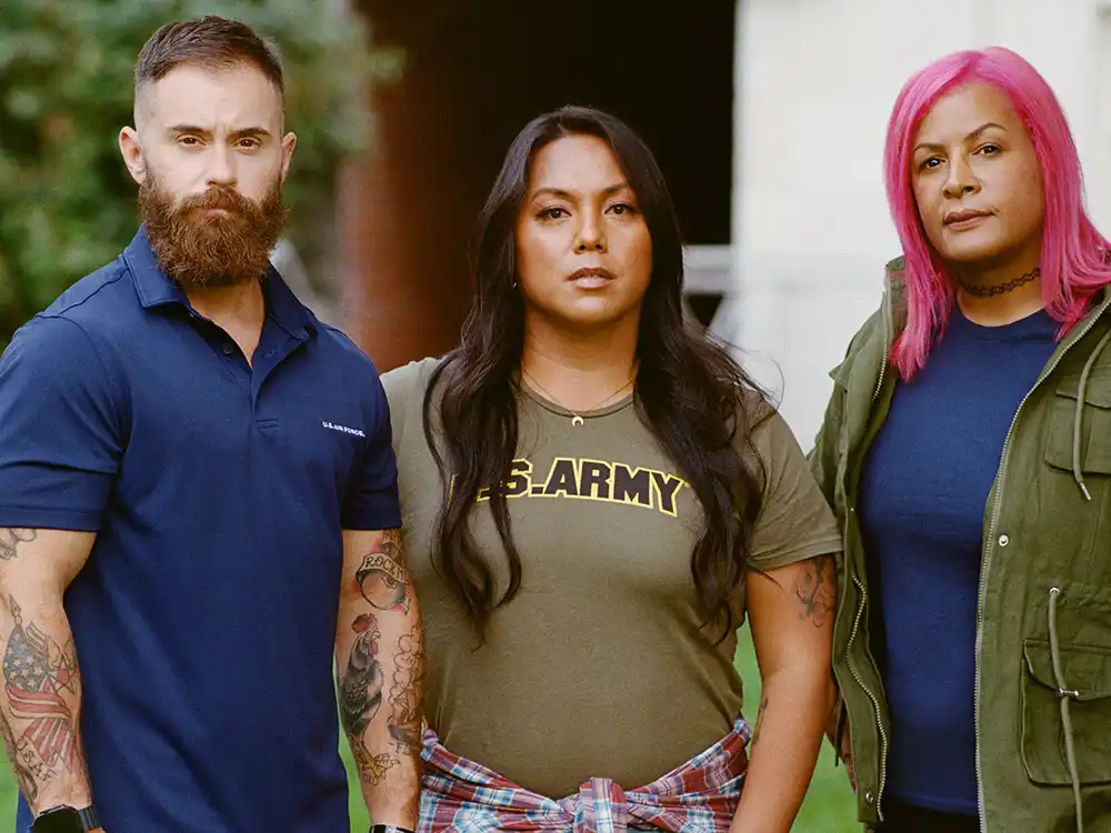Three people in U.S. Air Force, Army, and civilian clothes stand together outdoors, from Lambda Legal's All Rise campaign
