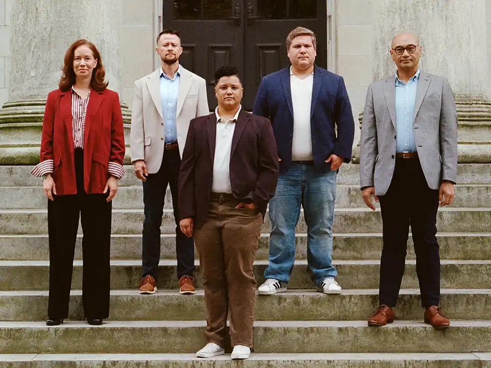 Five people in blazers stand on courthouse steps, from Lambda Legal's All Rise campaign