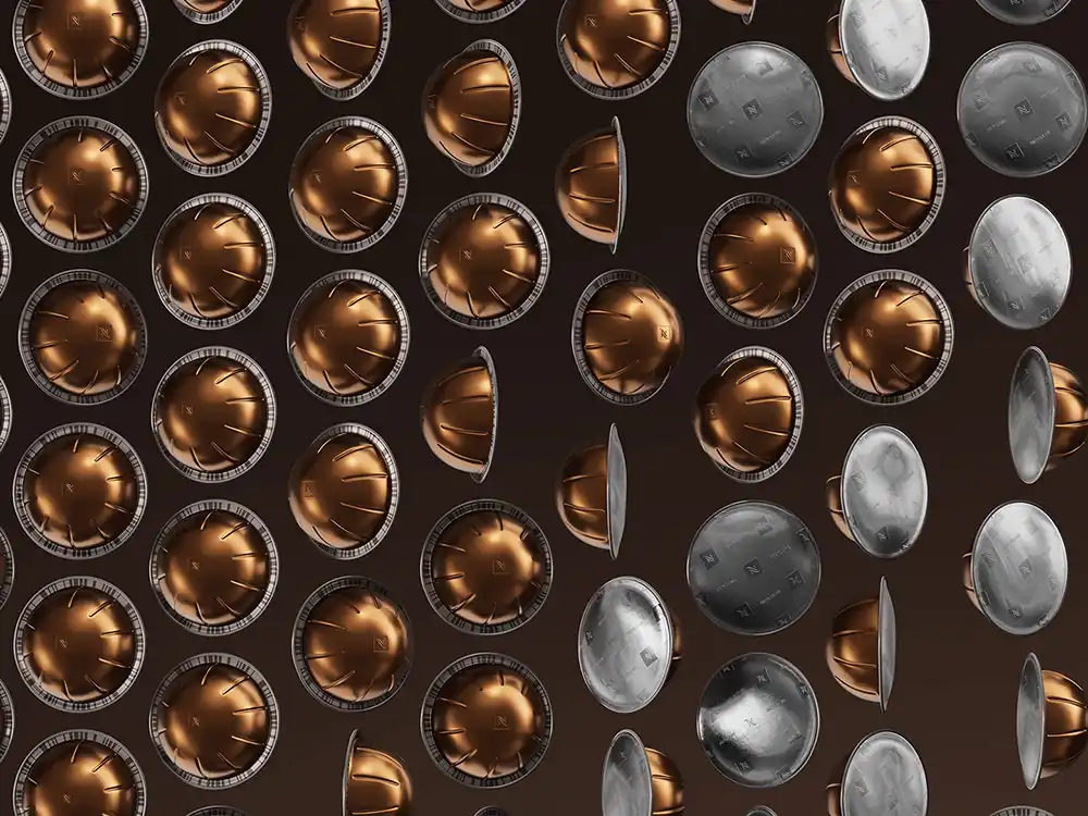 Copper and silver Nespresso capsules fill a dense grid on a dark field, from Innovation You Can Taste