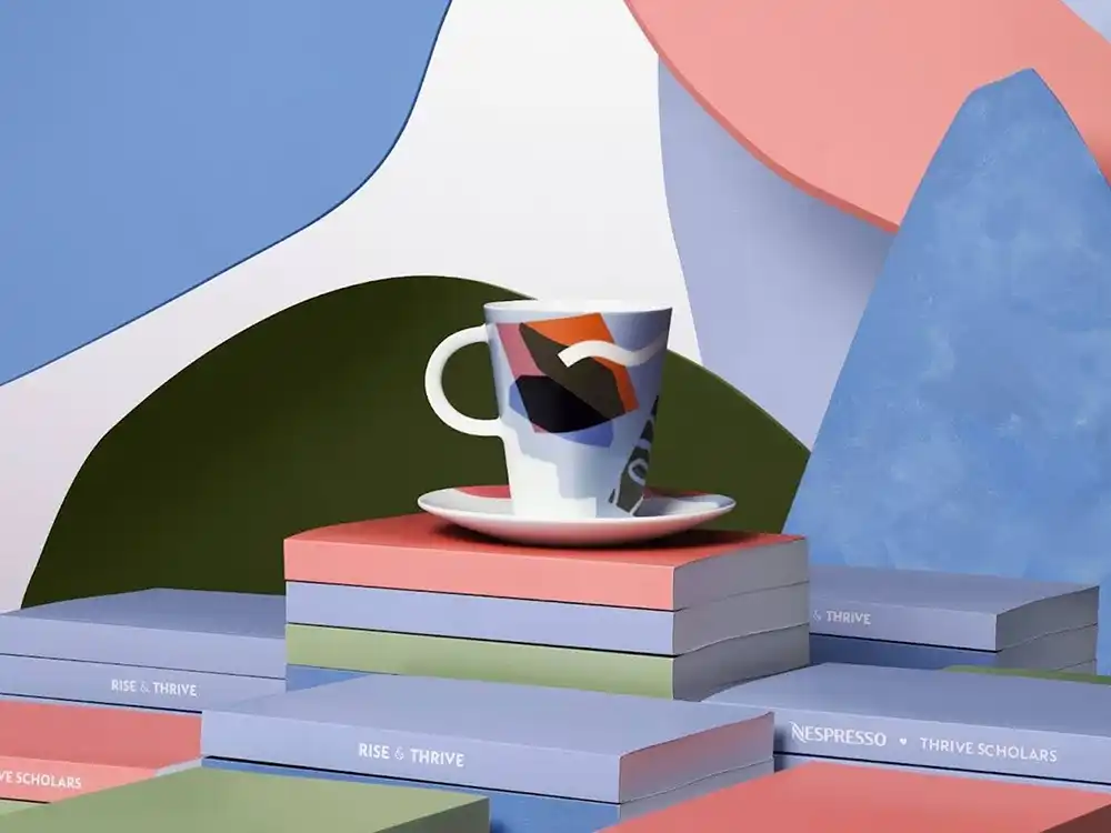 Abstract-print cup on stacked Rise & Thrive boxes for Nespresso Thrive Scholars, from Innovation You Can Taste