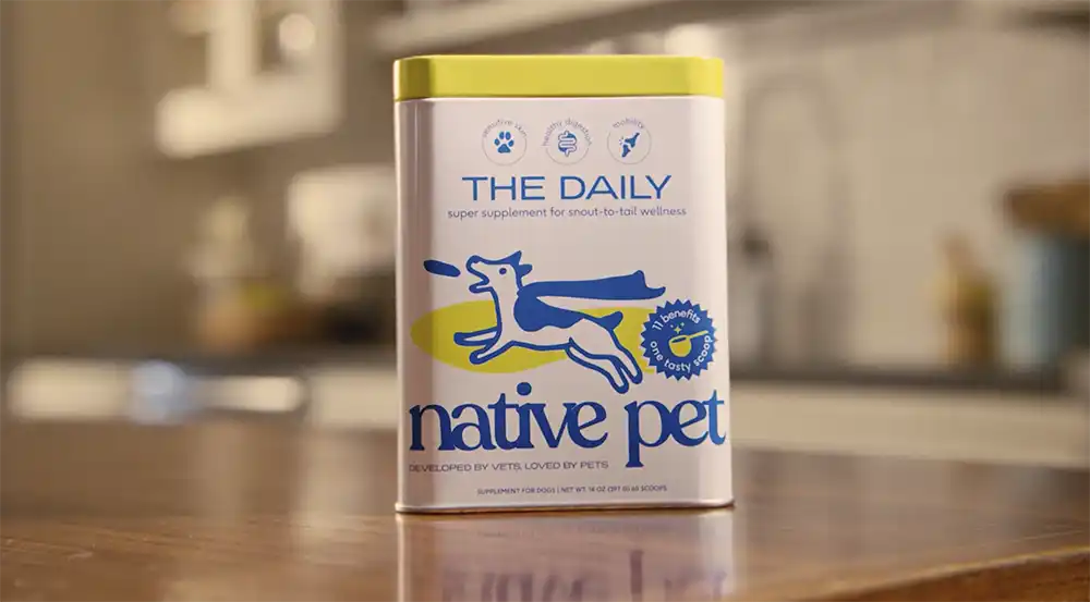 Native Pet The Daily supplement tin with a leaping dog sits on a kitchen counter, from Let Dogs Be Dogs in MediaPost